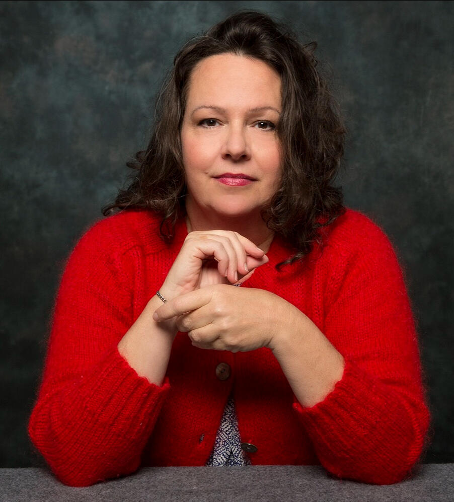 Liz Allen Headshot wearing red sweater